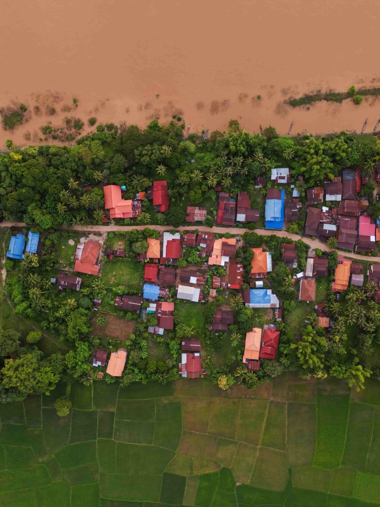 Village roofs and field boundaries form a pattern beside the river.
