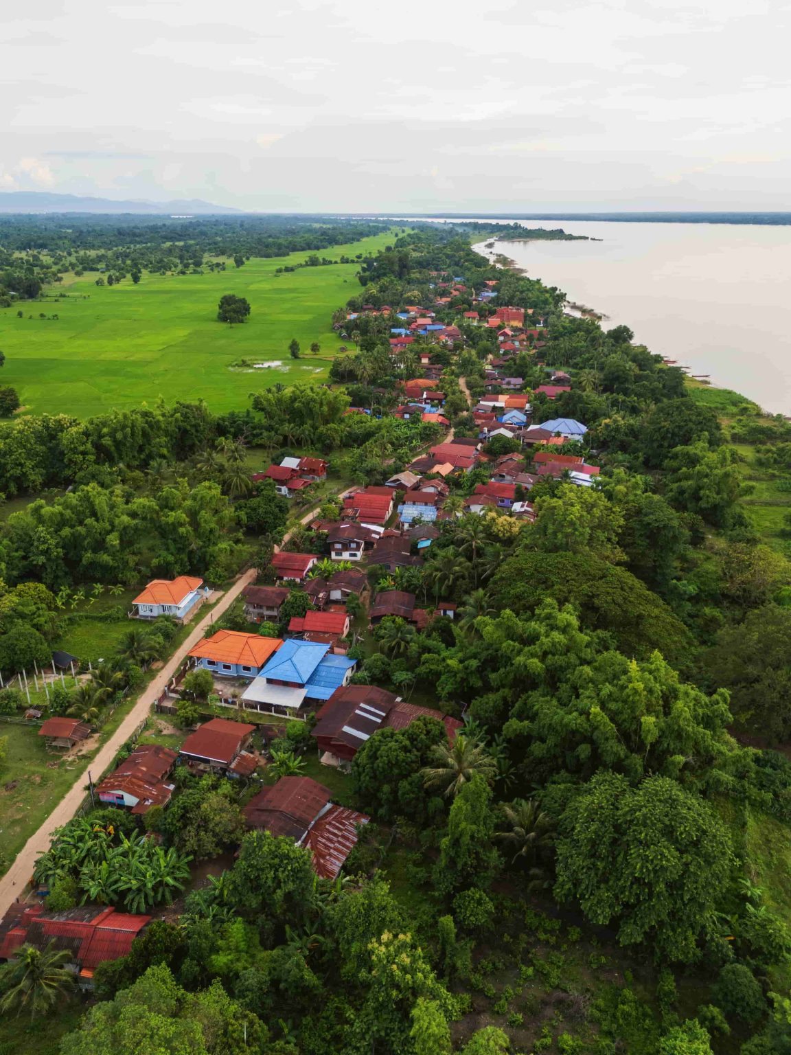 Homes sit between the fields and the river along the island’s edge.