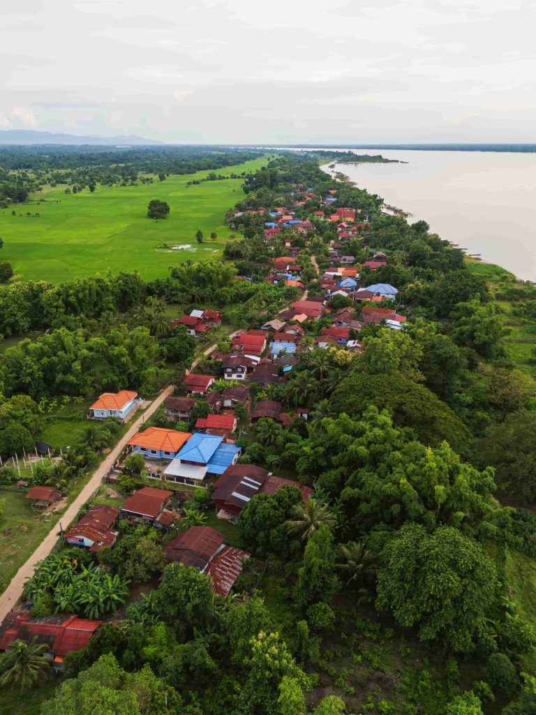Homes sit between the fields and the river along the island’s edge.