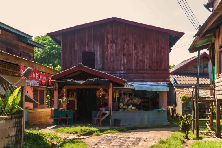 A wooden village building with an open frontage.