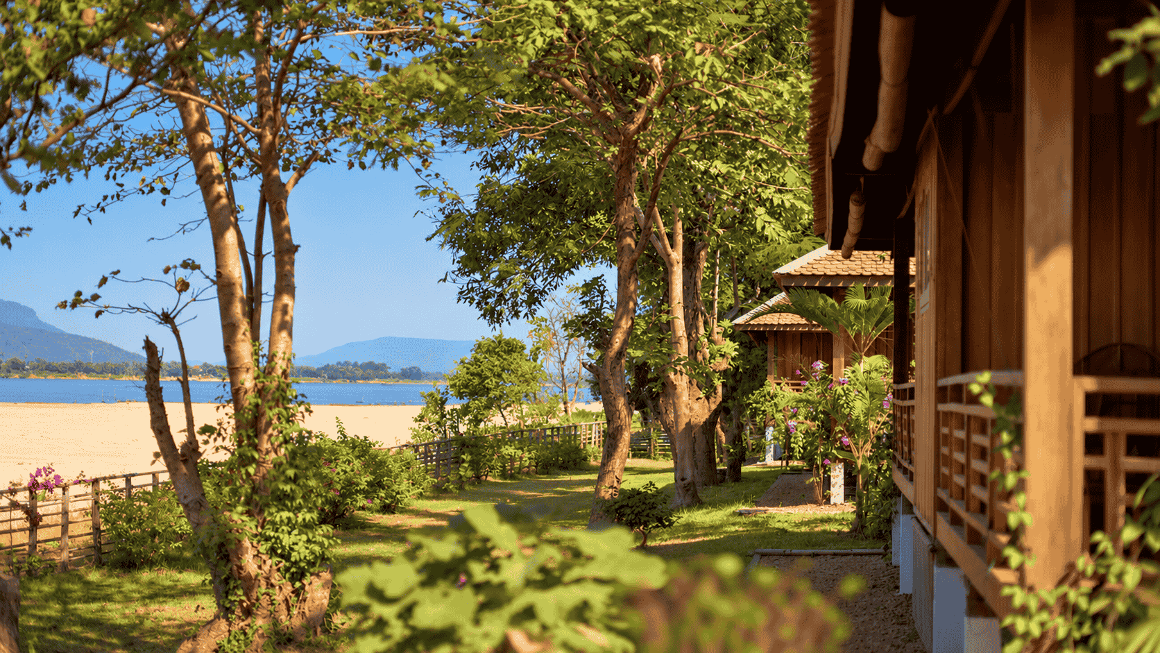 A garden path between the bungalows and the Mekong.